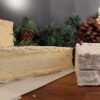 A wheel of truffled baron cut in half