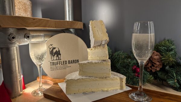 Truffled baron segments stacked and 2 glasses of champagne